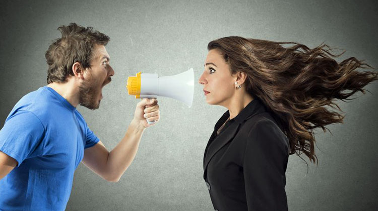 man shouting at woman through megaphone