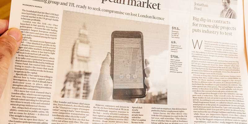 traditional newspaper with picture of smartphone