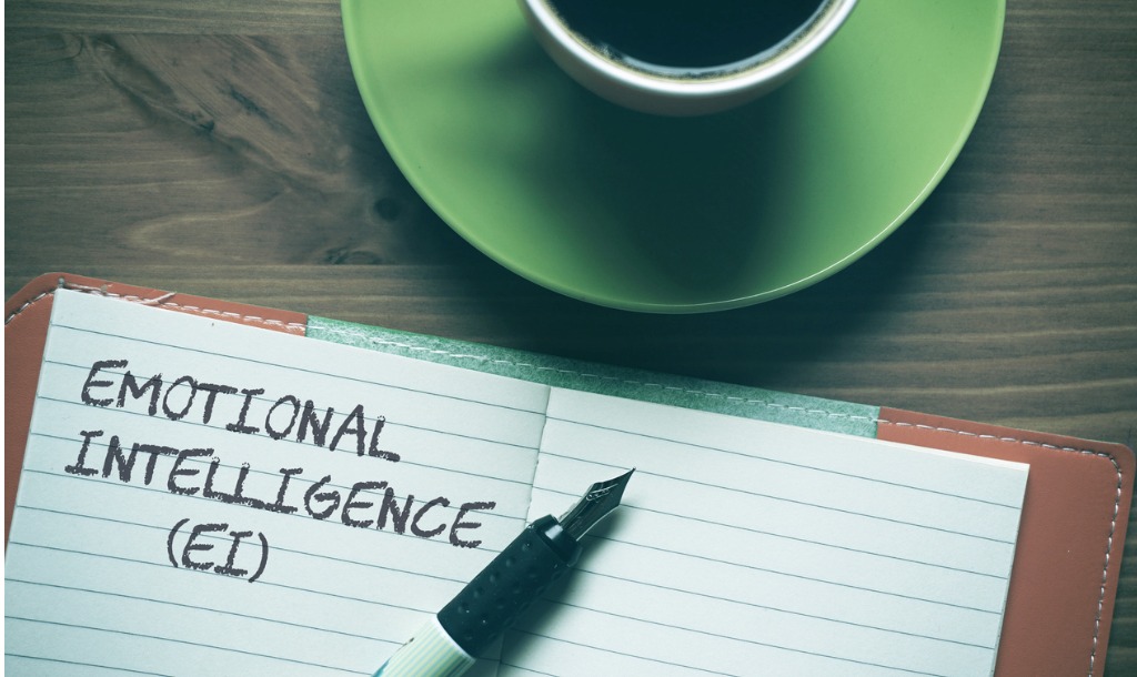 emotional intelligence with pen and coffee cup